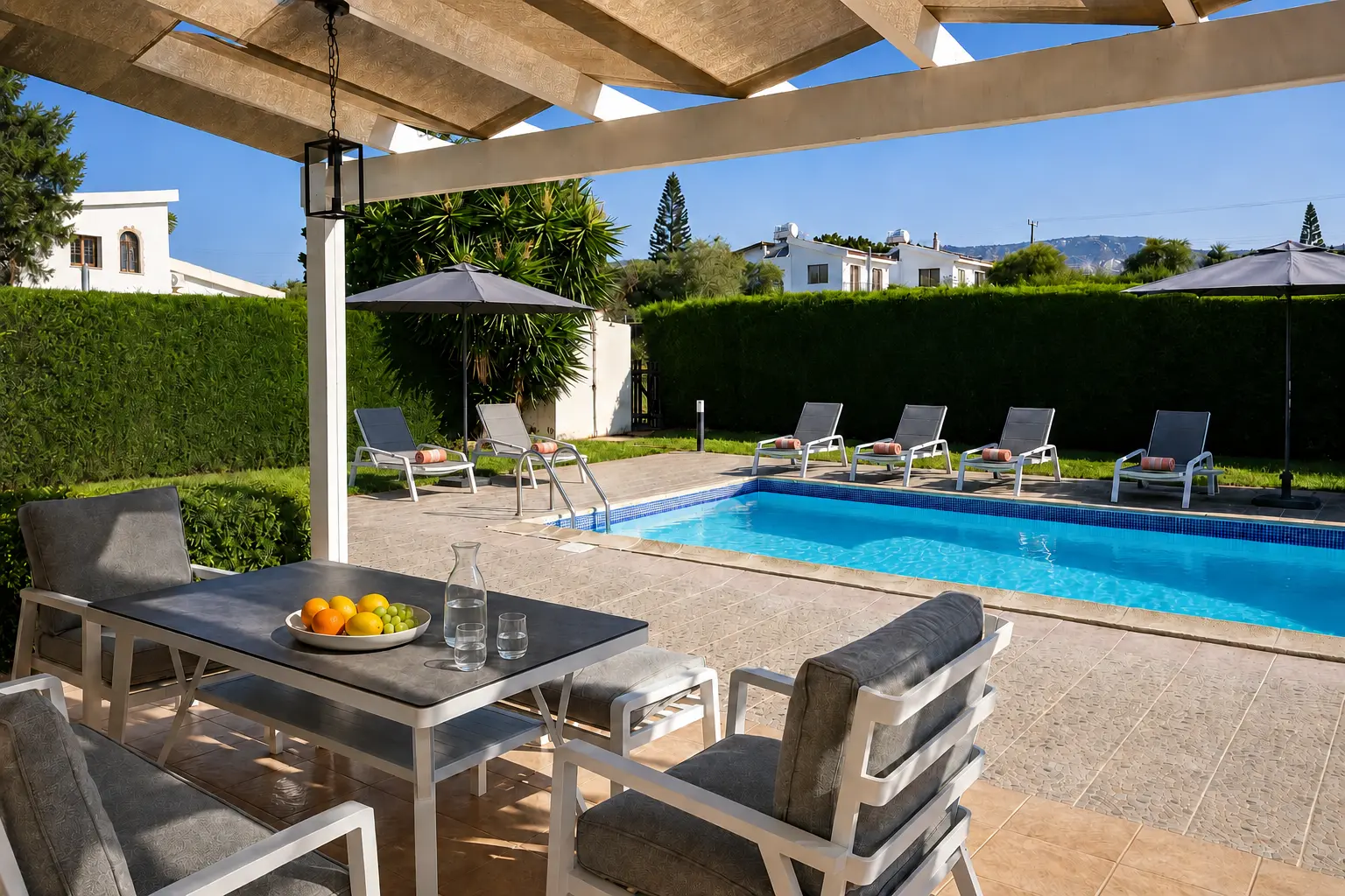 Private swimming pool with six sunbeds and shaded dining terrace at Villa Ondine